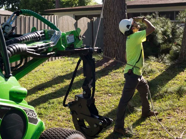 Crew and green spider loader on a slope — tree service in Jacksonville, FL by Jax Tree Removal